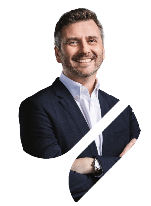 A professional portrait of Watson-Marlow Managing Director Stuart Roby in the Spirax Group S shape. He has his arms crossed and is looking directly at the camera and smiling