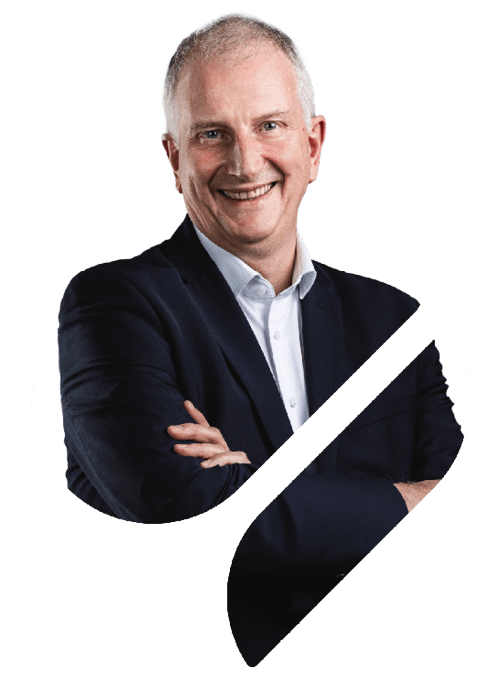 A professional portrait of Electric Thermal Solutions Managing Director Andrew Mines in the Spirax Group S shape. His arms are folded and he is looking at the camera directly while smiling.