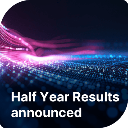 Pink and blue lights in lines are the backdrop to the text in white at the bottom of the image saying 'Half Year Results announced'.