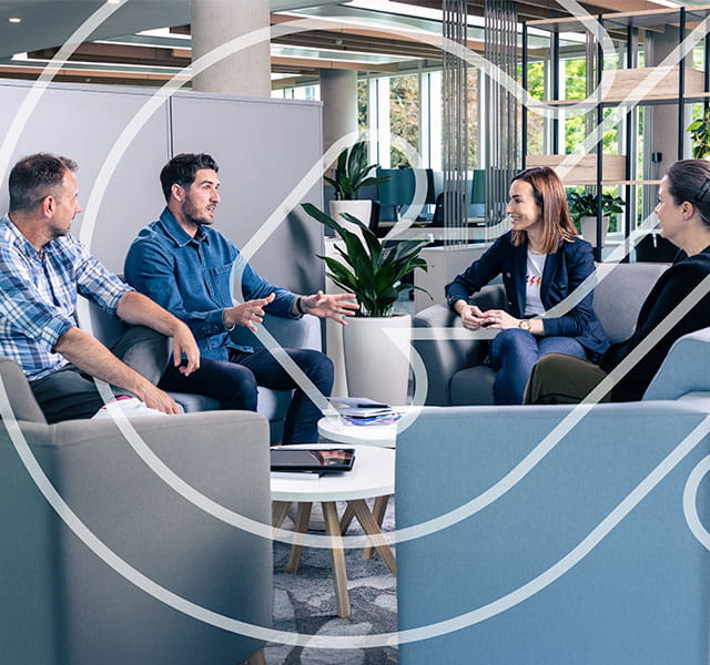Three people sit in a casual office environment talking with Maria Wilson. The CONNECT symbol is overlaid in white