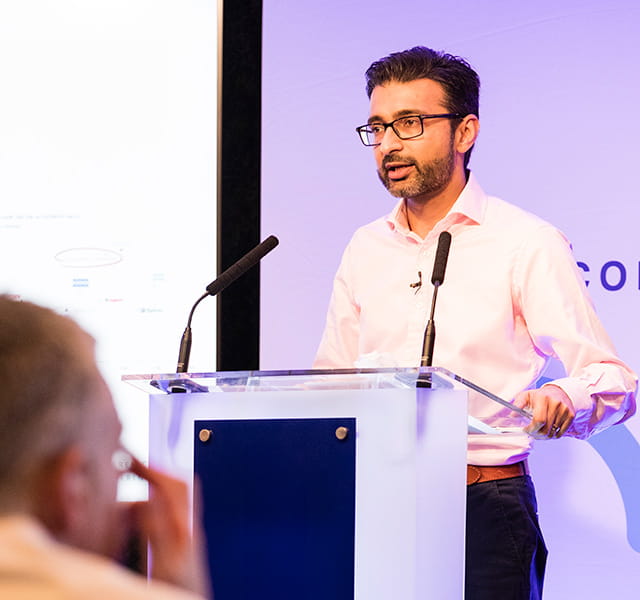 CEO Nimesh Patel talking from a lectern