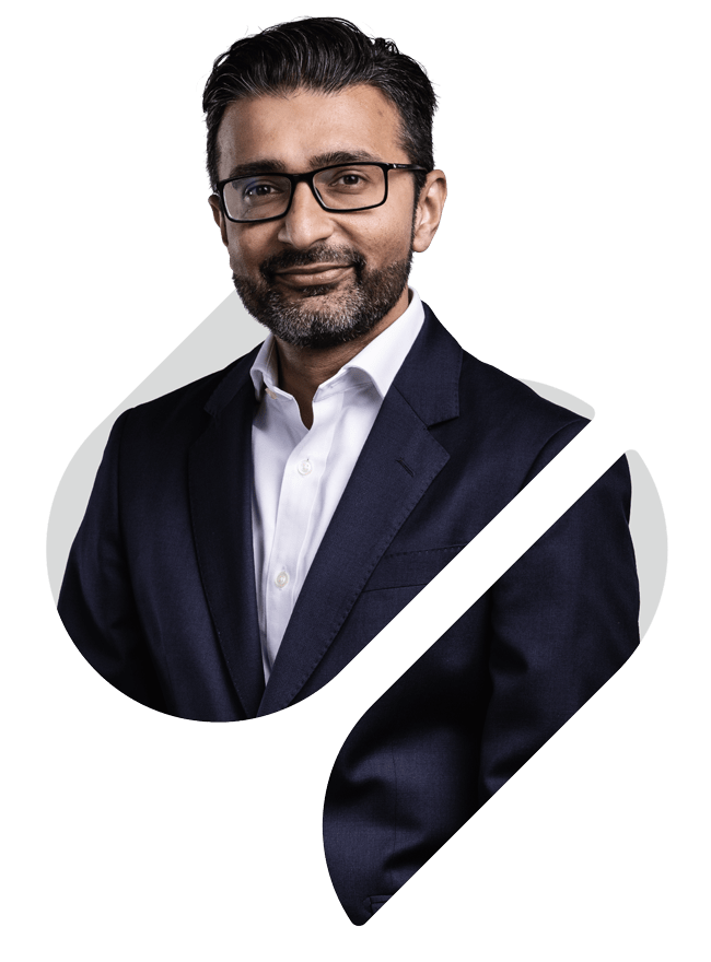 A smart casual headshot of Group CEO Nimesh Patel