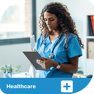 A woman in scrubs and a stethoscope is writing on a keyboard. A blue tab sits beneath the picture with a cross icon next to the word Healthcare