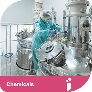 A worker in a chemical site in full covering. There is a pink tab beneath the image with the text 'chemicals' with a test tube icon.