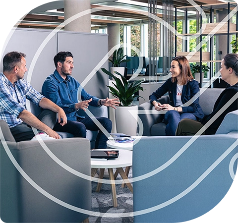 Three people sit in a casual office environment talking with Maria Wilson. The CONNECT symbol is overlaid in white